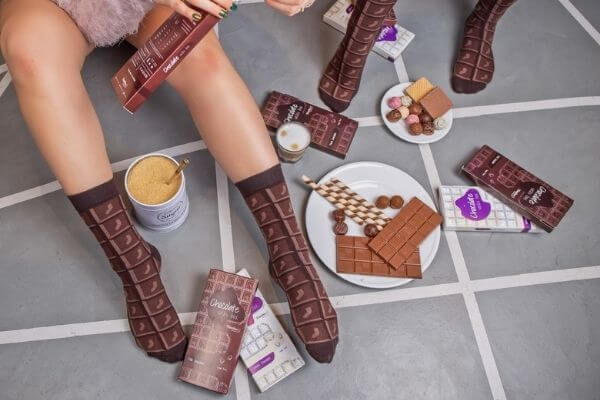Chocolate, sweets and two people wearing brown socks.